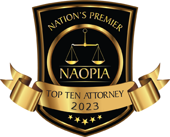A gold and black crest featuring scales of justice, the text NAOPIA, and Nations Premier Top Ten Attorney 2023.