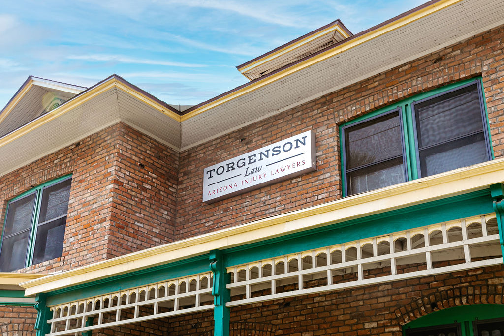 Brick building with a sign reading Torgenson Law, Arizona Injury Lawyers mounted on the exterior wall.