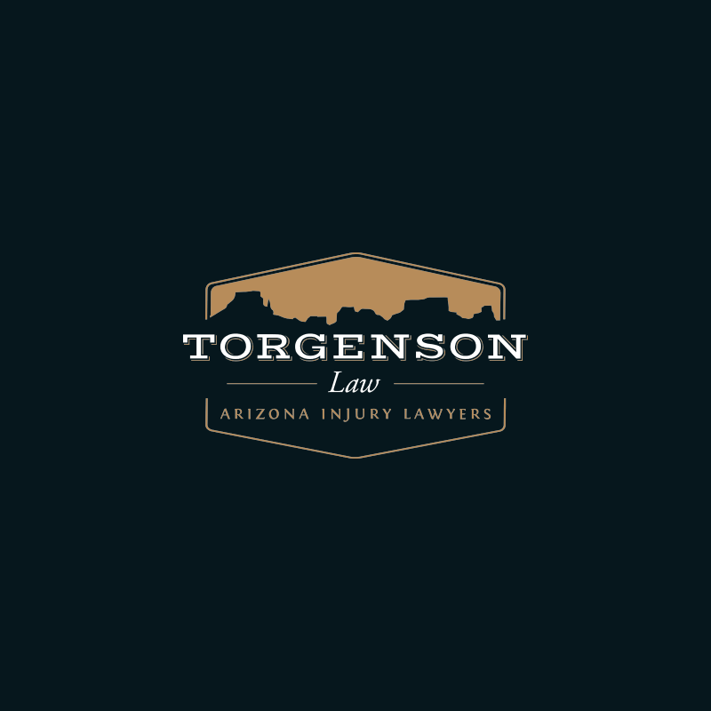 Logo for Torgenson Law, Arizona injury lawyers, featuring a desert mesa silhouette inside a badge shape.