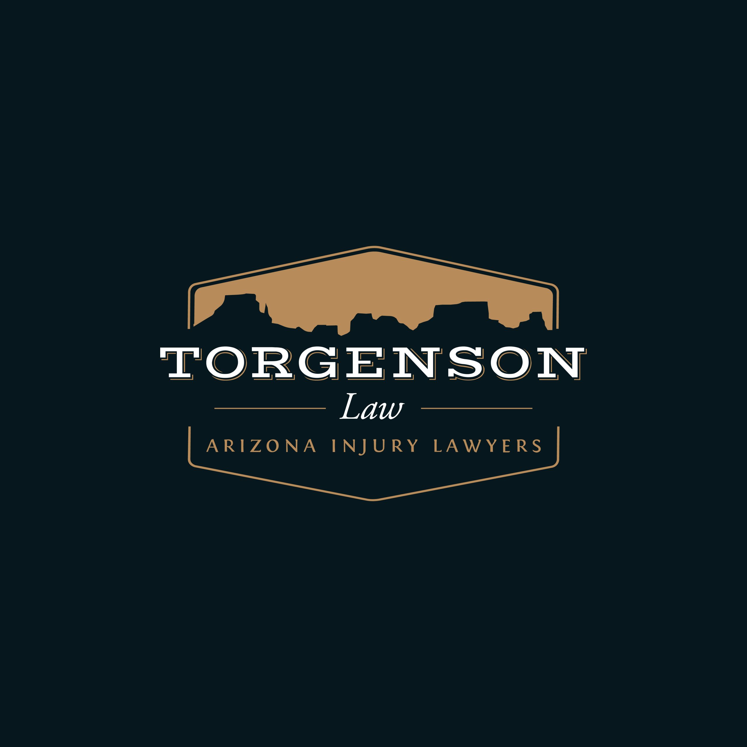 Logo for Torgenson Law, Arizona injury lawyers, featuring a desert mesa silhouette inside a gold emblem on a dark background.
